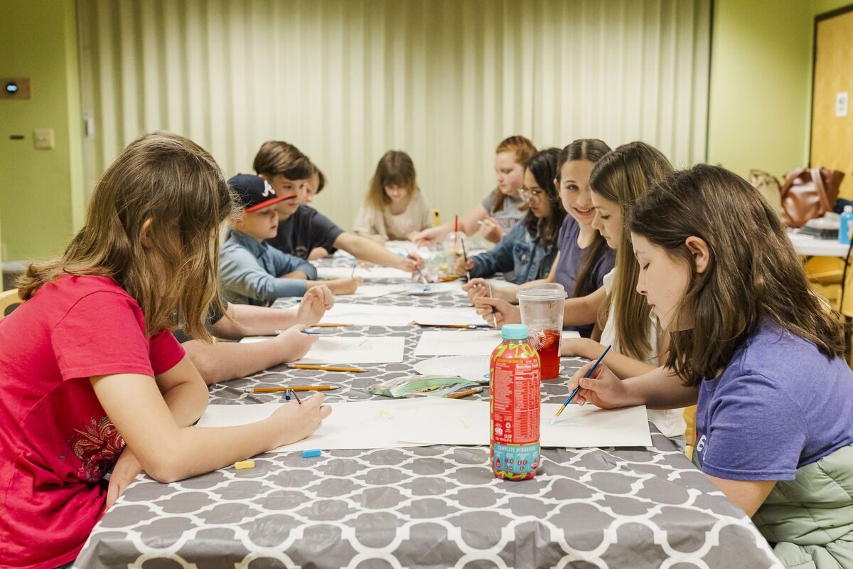 Children drawing and creating art at a table