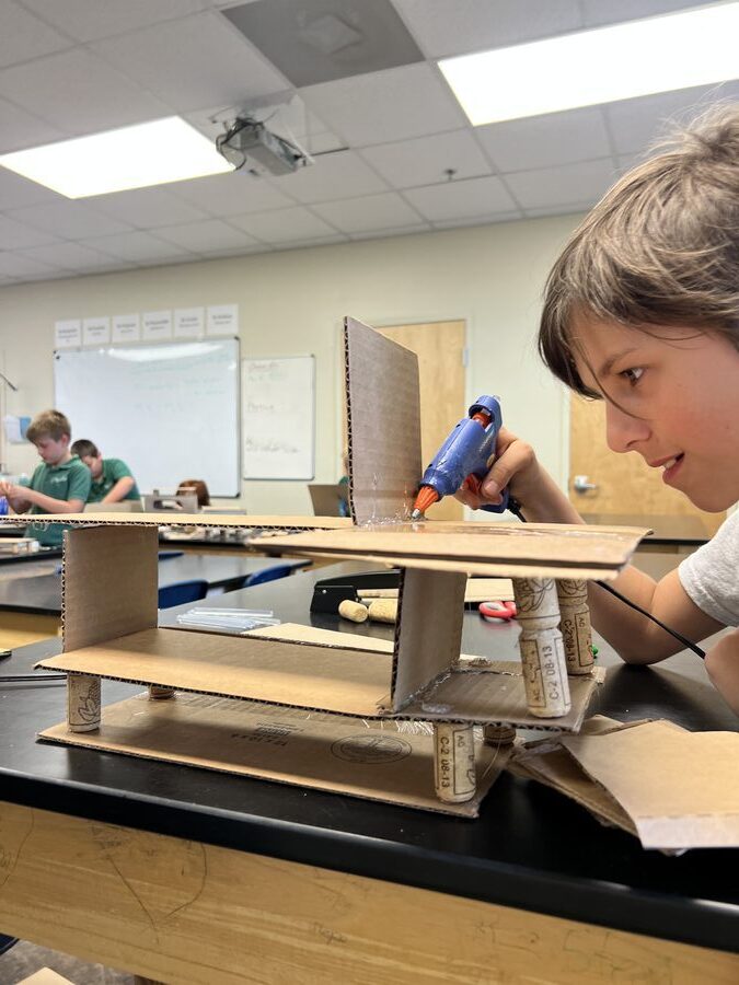 Engineering & Design Camp — kid building with a glue gun
