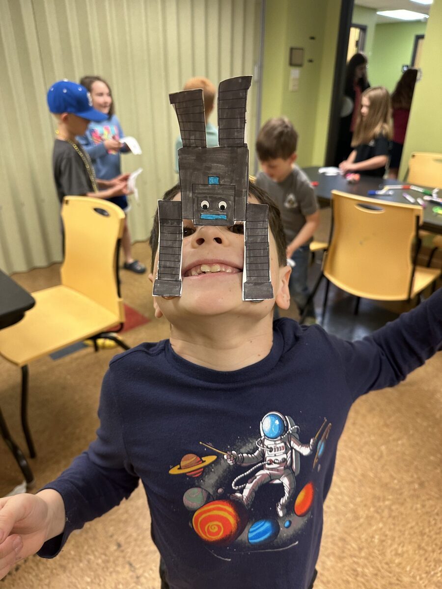 Boy wearing a robot mask he built at STEAMCamp