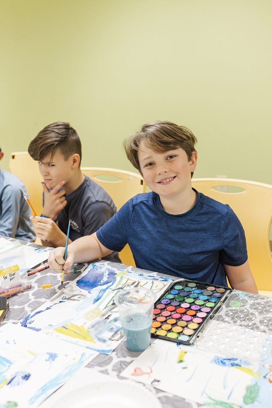 Boy painting watercolor