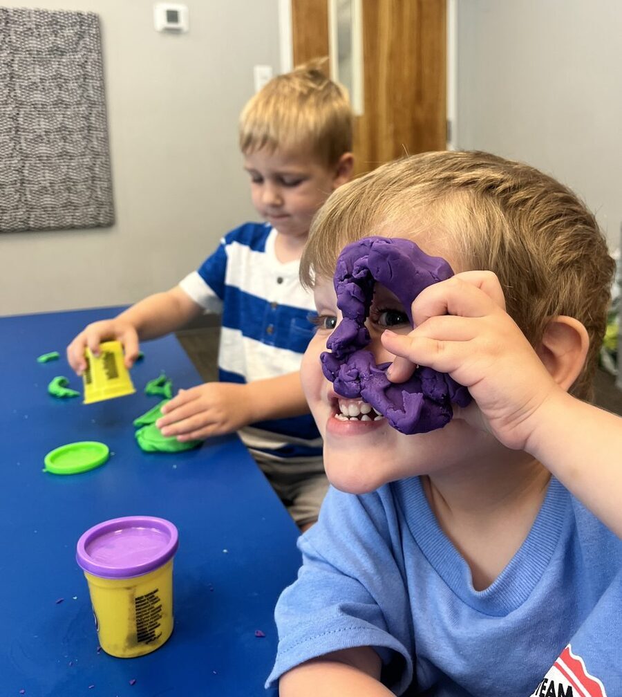Preschool boys enjoying play-doh sculpting activity