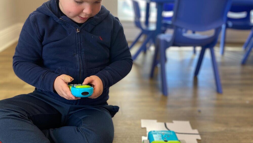 Child learning robotics at STEAMCamp
