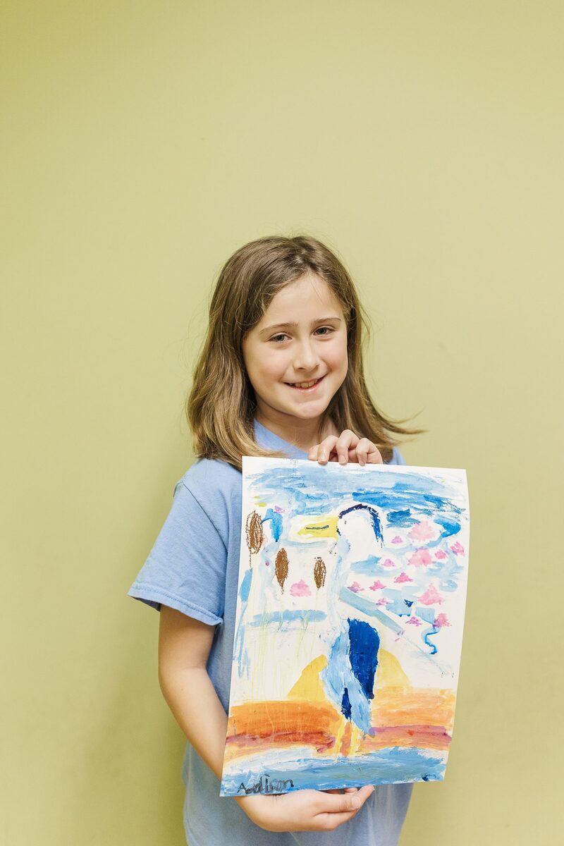 Girl showing her painting