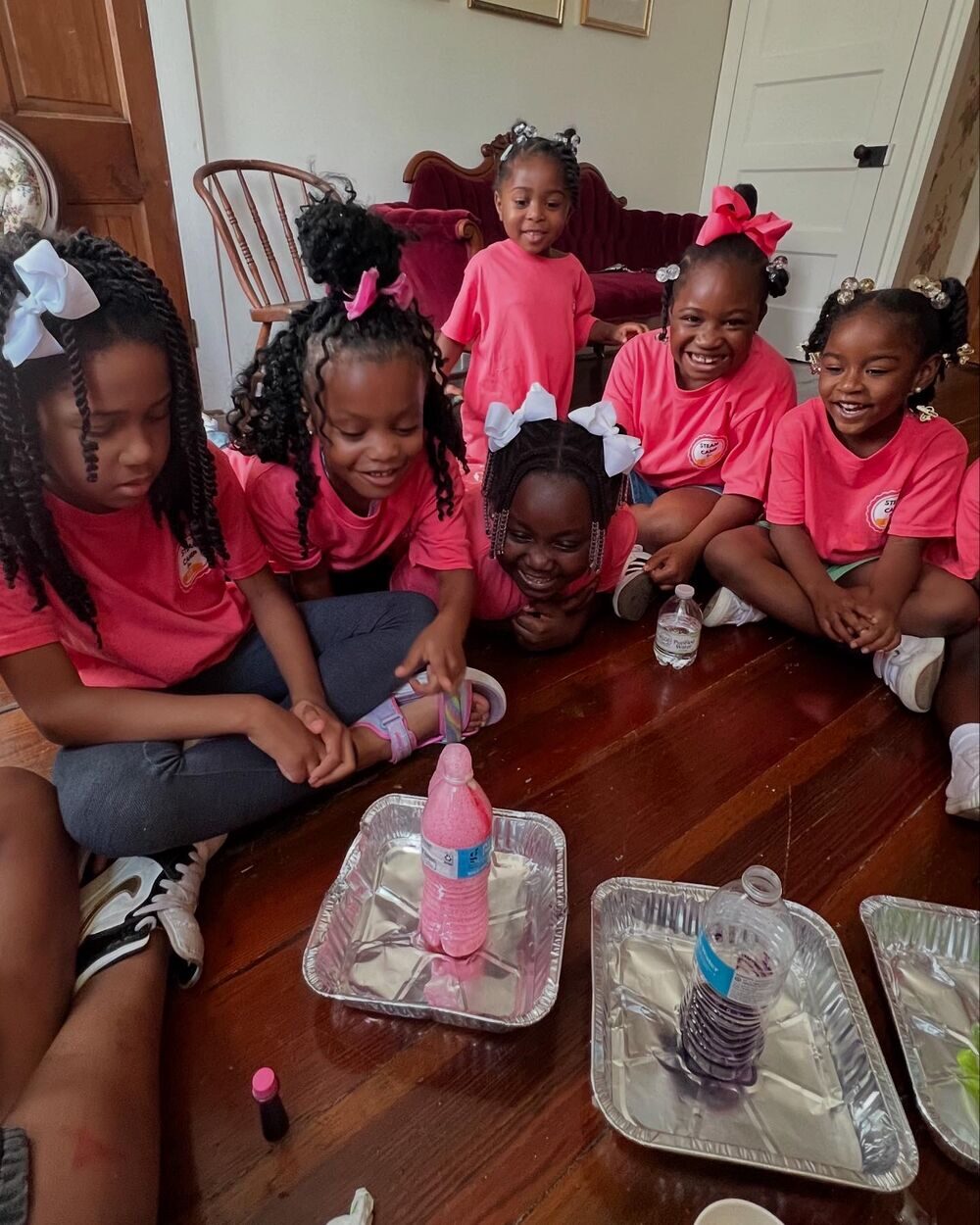 Girls conducting a science experiment at STEAMCamp