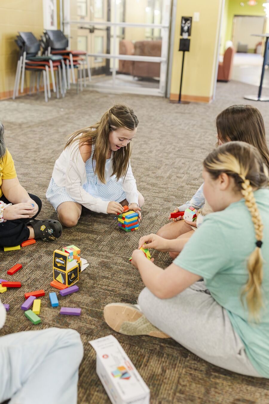 Homeschool students collaborating with colorful building blocks